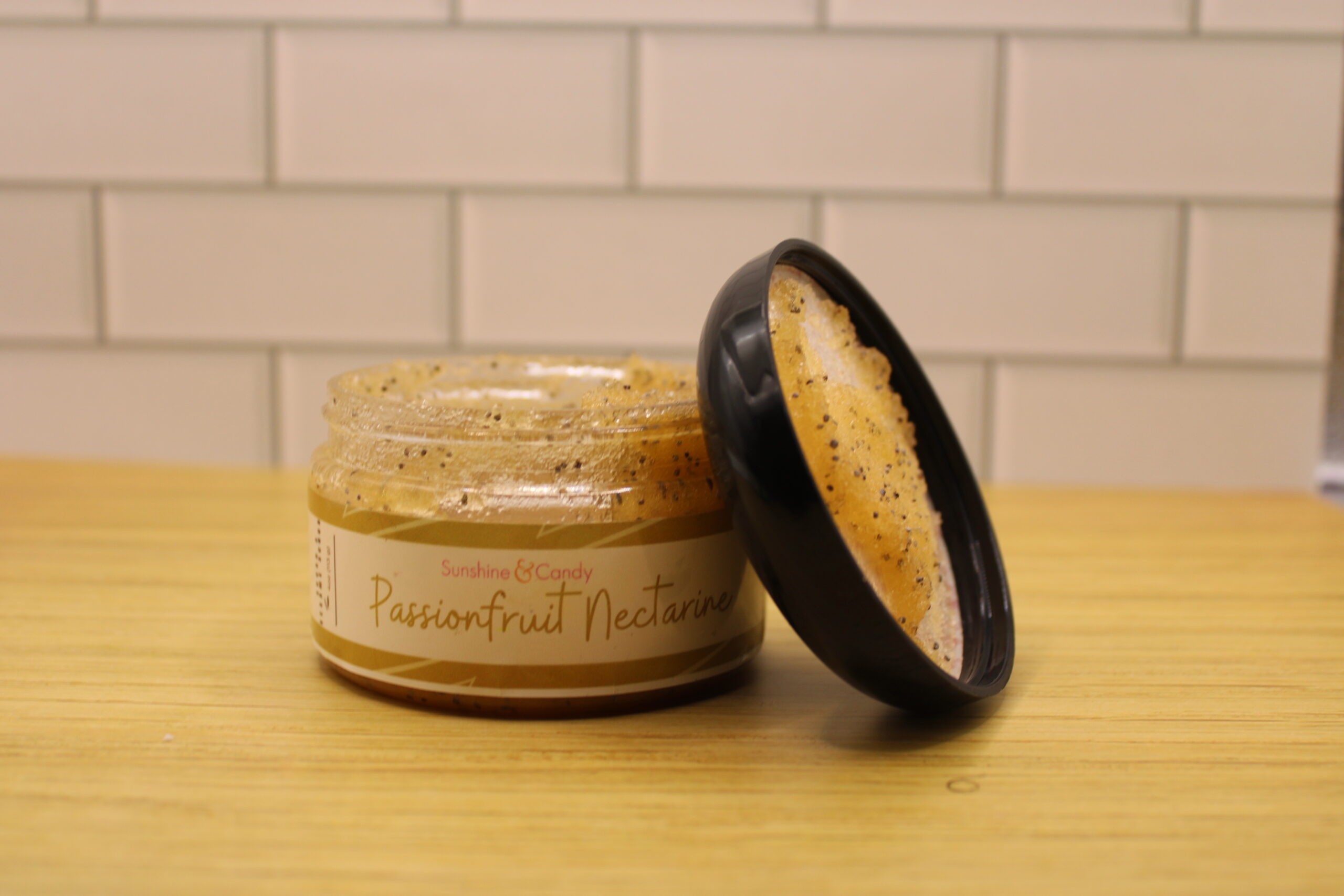 Tropical-inspired jar of Passion Fruit Nectarine Sugar Scrub with visible sesame seeds and natural oils—ideal for full-body exfoliation and glowing skin.