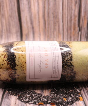 Glass jar of Soothing Spa Salts with visible rose petals, pink and black salt crystals—perfect for muscle relief and a luxury spa day at home.